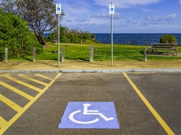 A car parking space with the disability symbol.