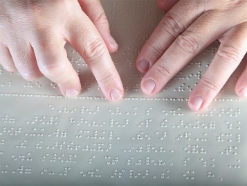 A person using Braille